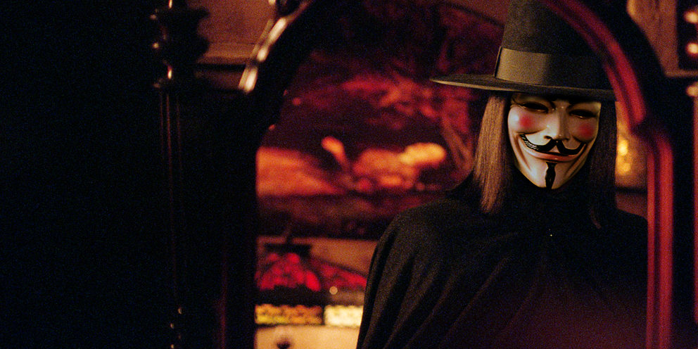 גבר עוטה גלימה שחורה ומגבעת תיתורה עם מסכה